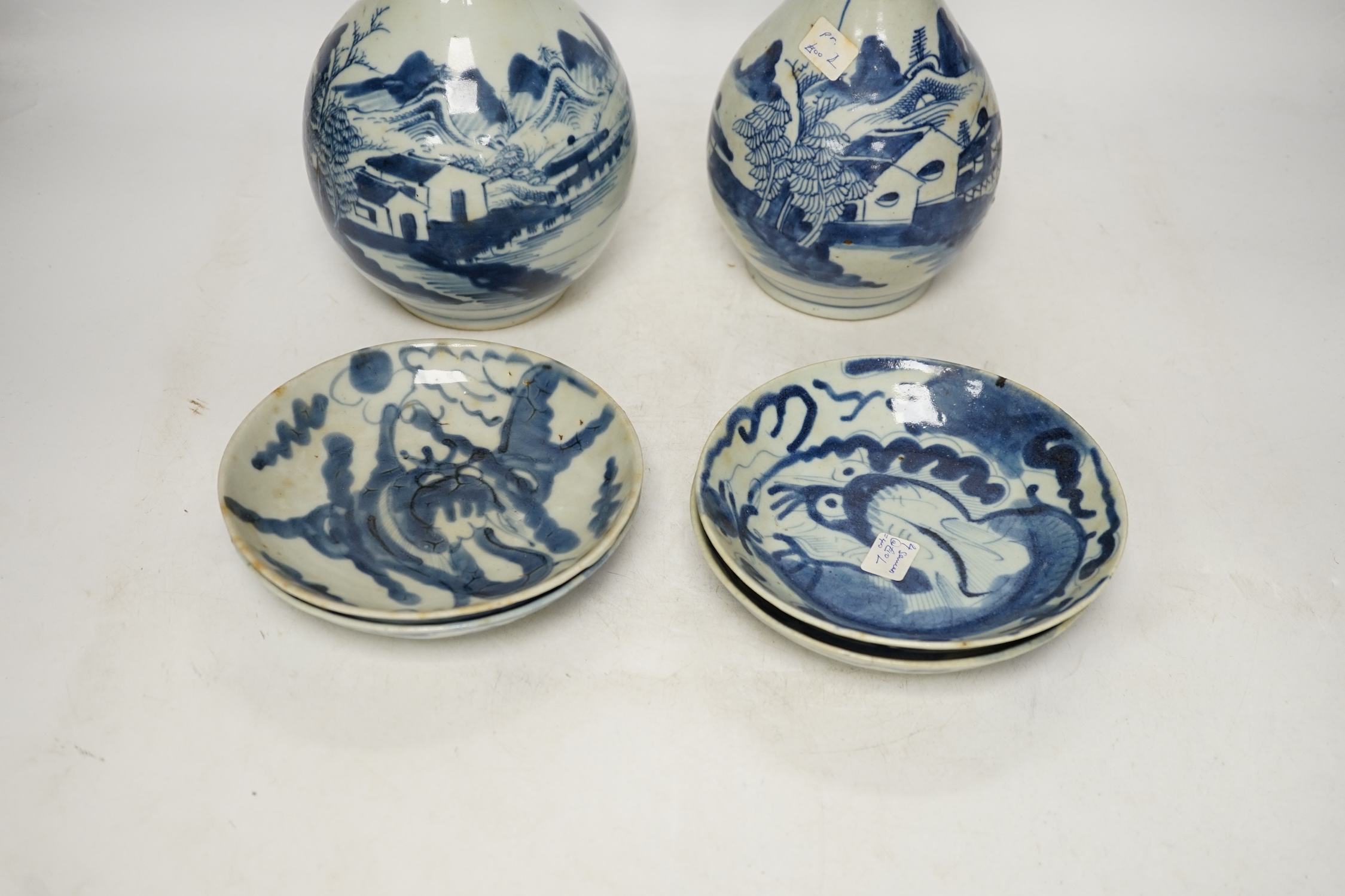 Two 18th century Chinese blue and white guglet bottles and four 19th century Chinese blue and white 'dragon' dishes, tallest 25cm. Condition - fair